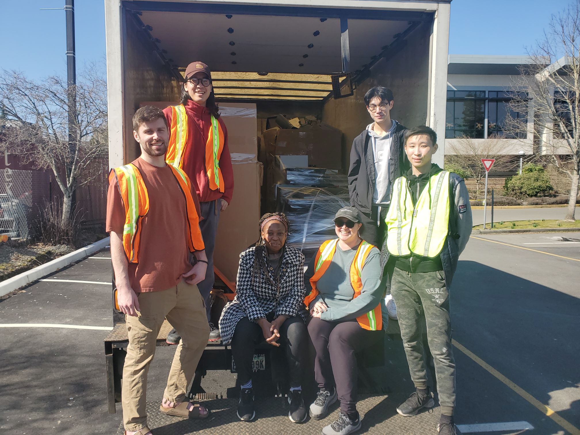 Picture of students standing in back of truck holding collected ewaste