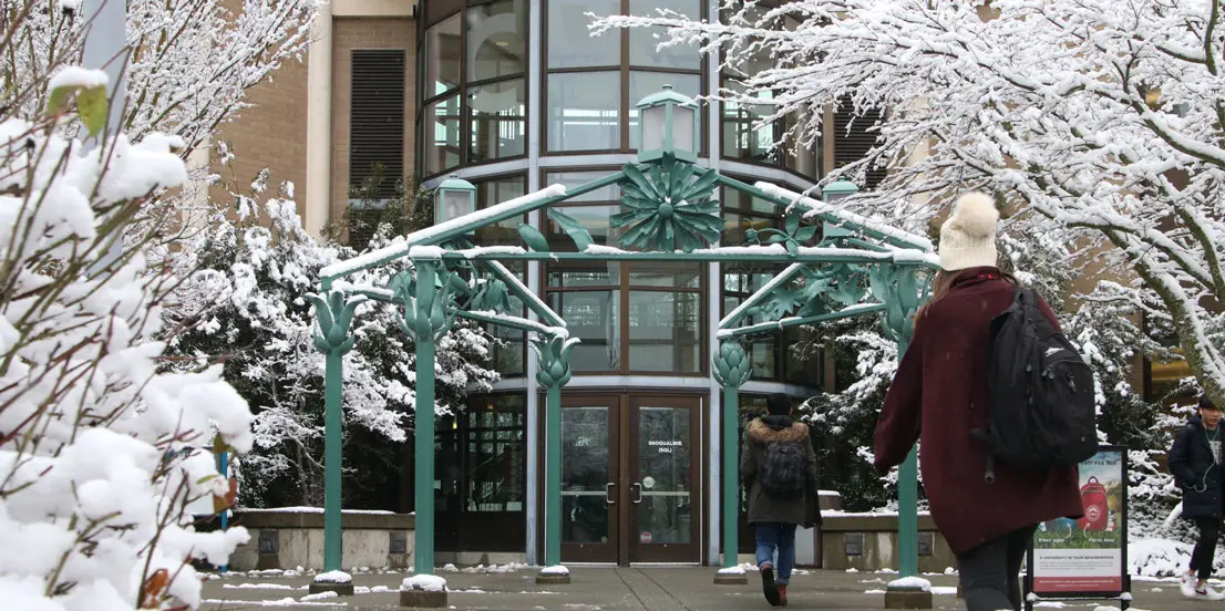 students walking through snowy campus